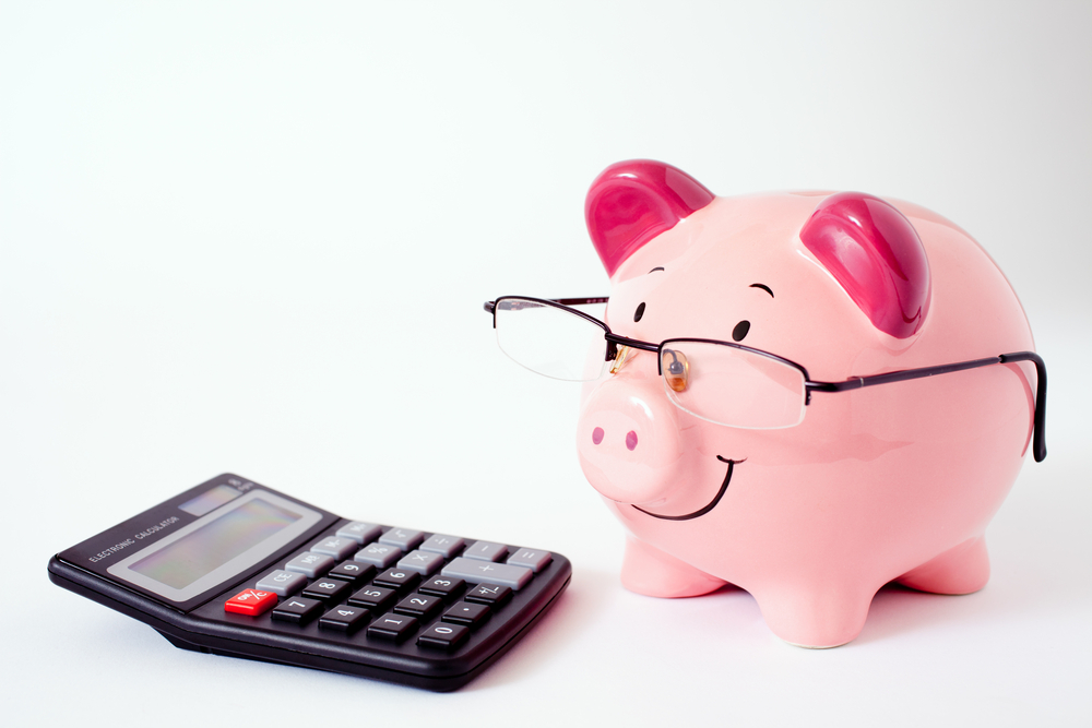 Piggy bank with calculator. Saving money concept.