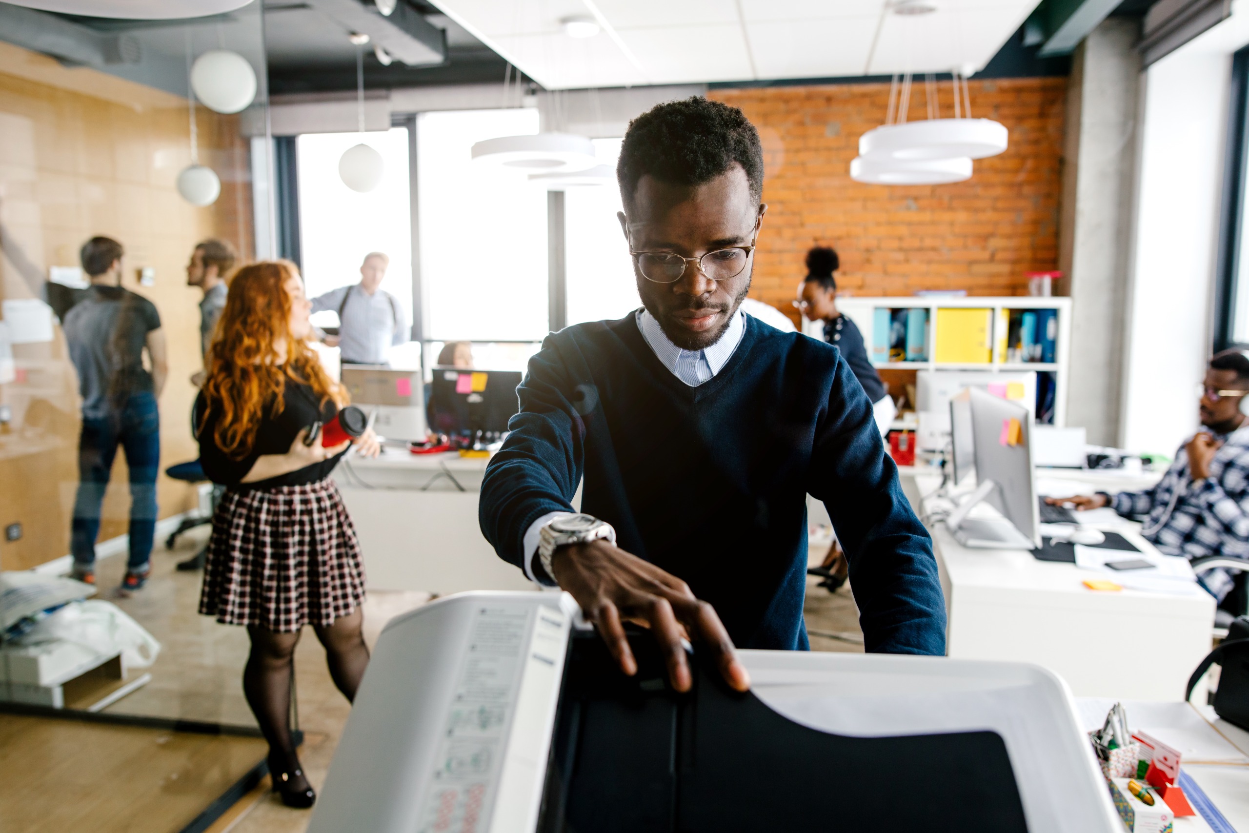 closeup portrait of man printing a file , document in the office room. Accounting concept