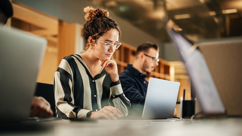 people working on computers using Microsoft 365.