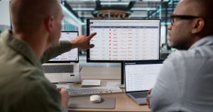 IT professionals reviewing cybersecurity risk management dashboards during a security assessment.