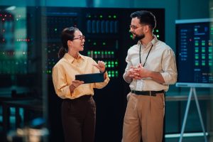 IT professionals reviewing server infrastructure and cybersecurity systems as part of a cyber resilience and business continuity strategy.